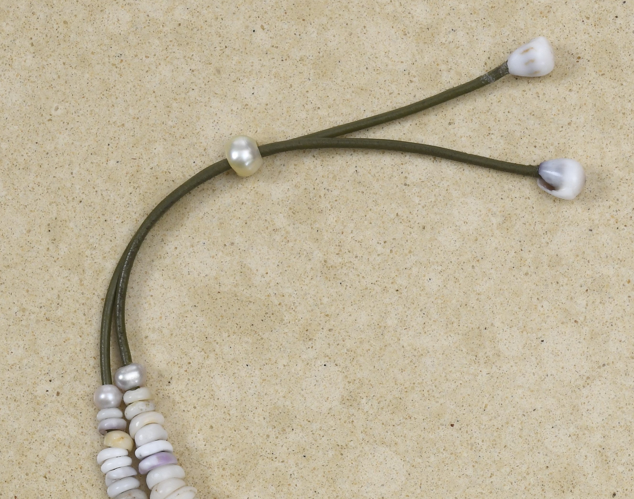 Puka lei with pink Edison pearl on green leather adjustable cord