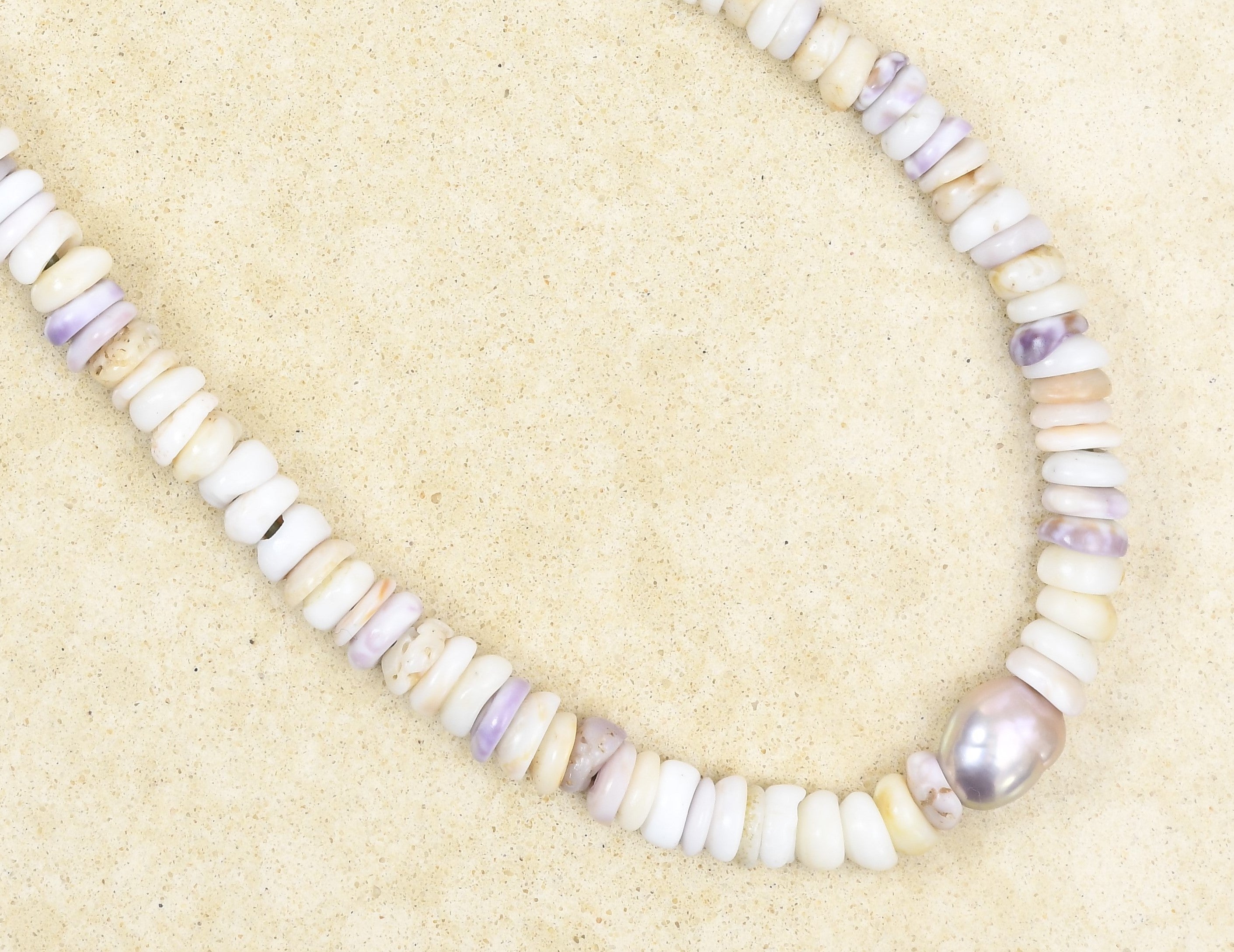 Puka lei with pink Edison pearl on green leather adjustable cord