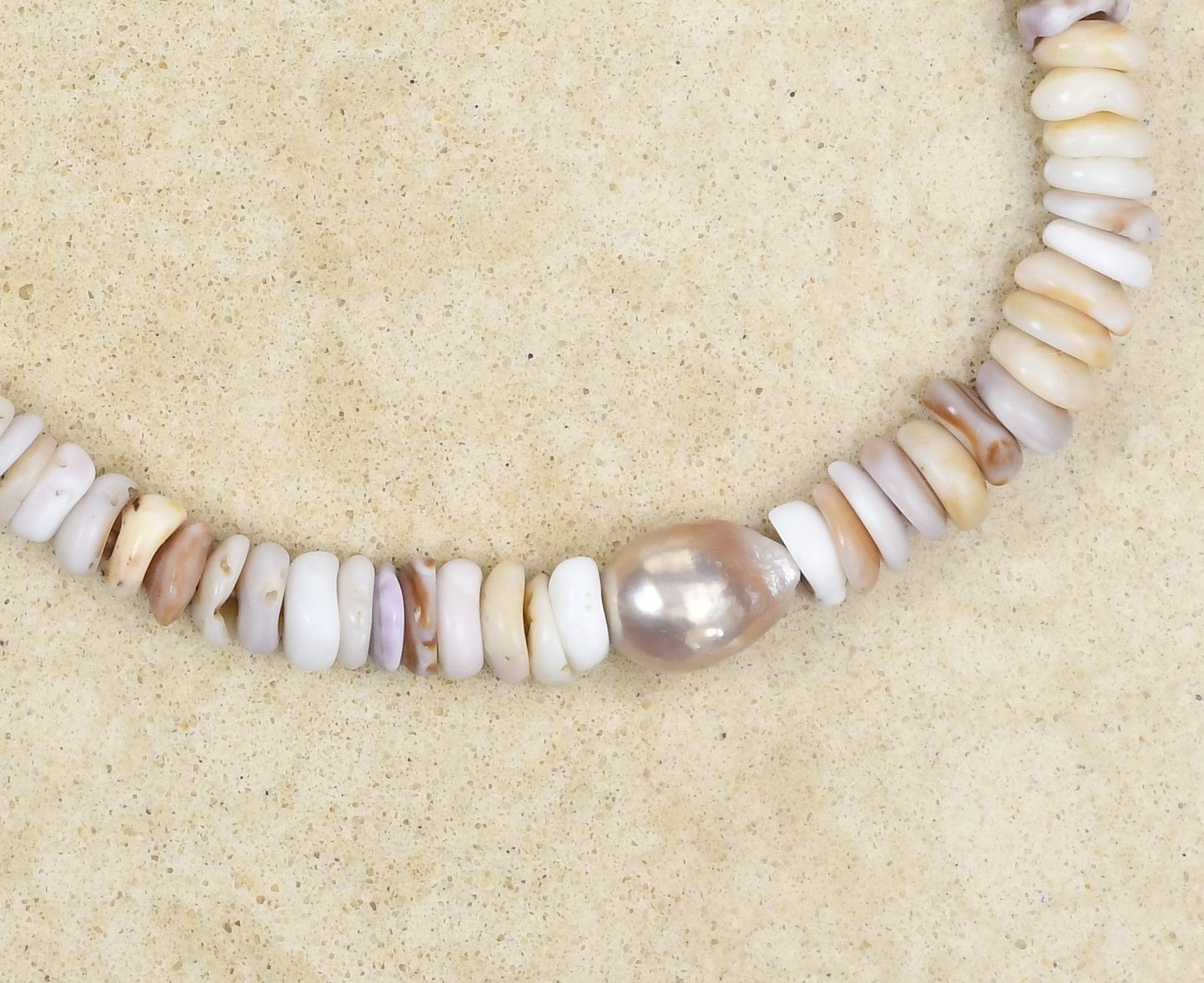 Puka lei with pearls on brown leather cord adjustable