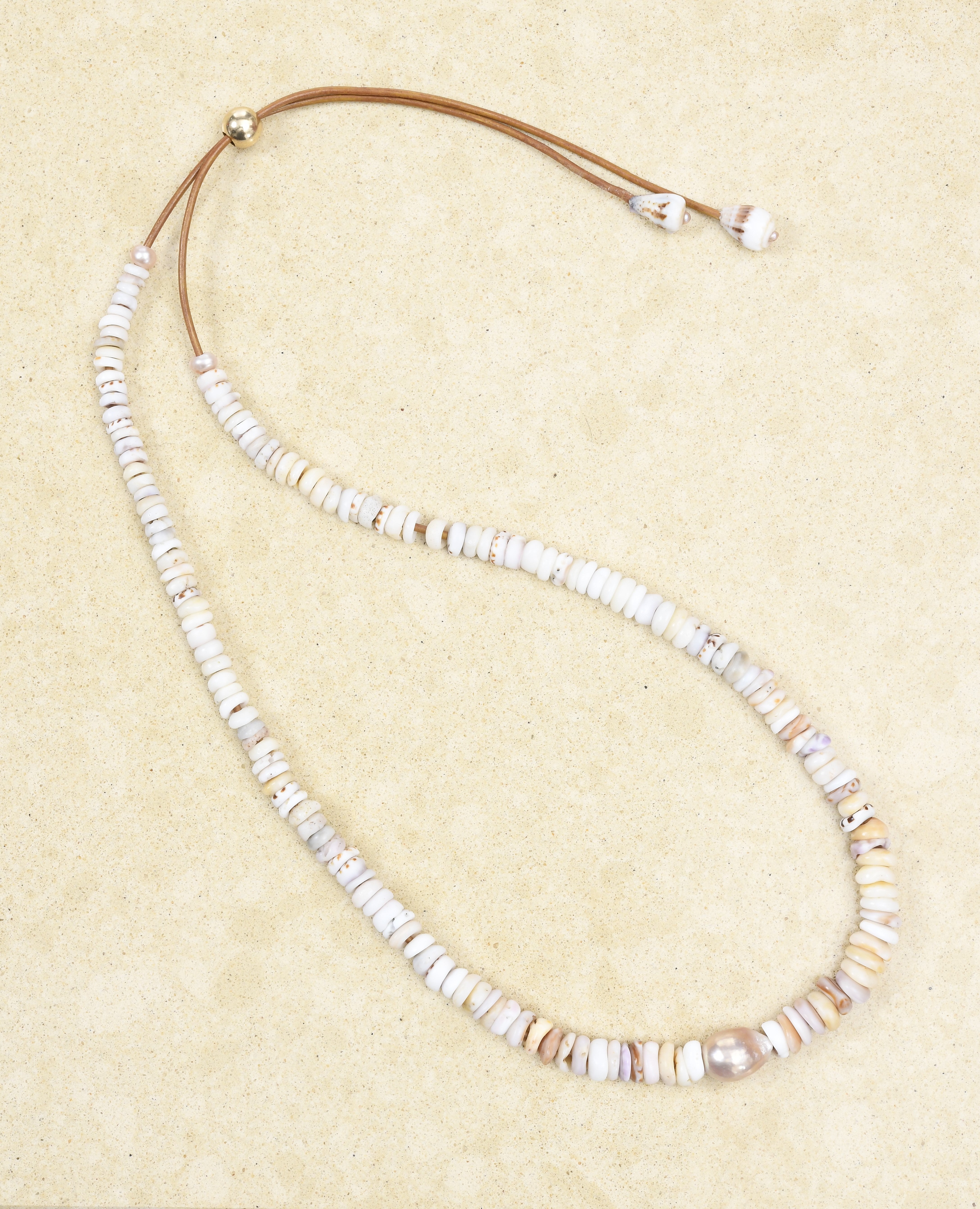 Puka lei with pearls on brown leather cord adjustable