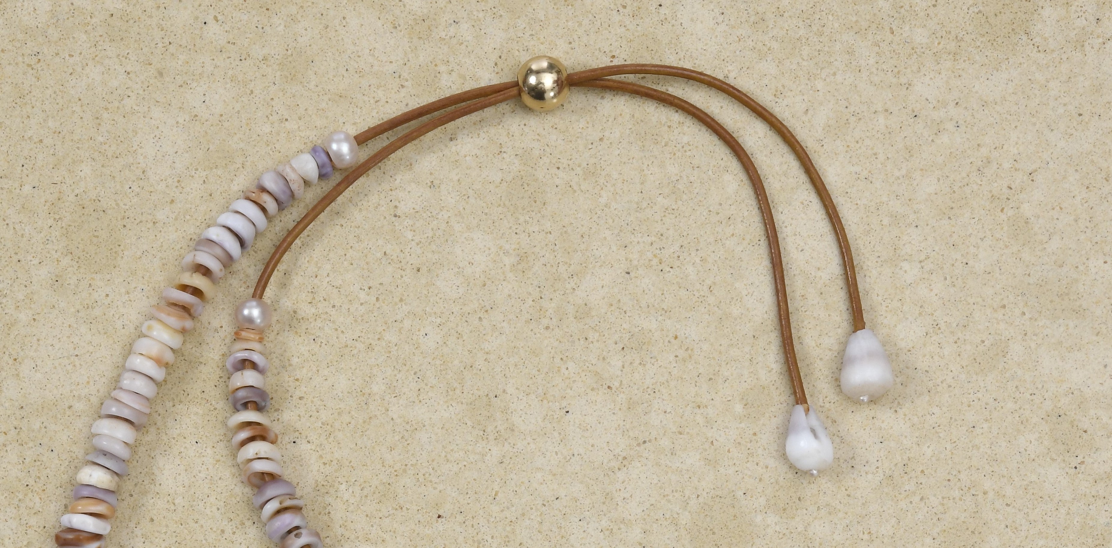 Puka lei with silver Baroque pearl and brown adjustable cord