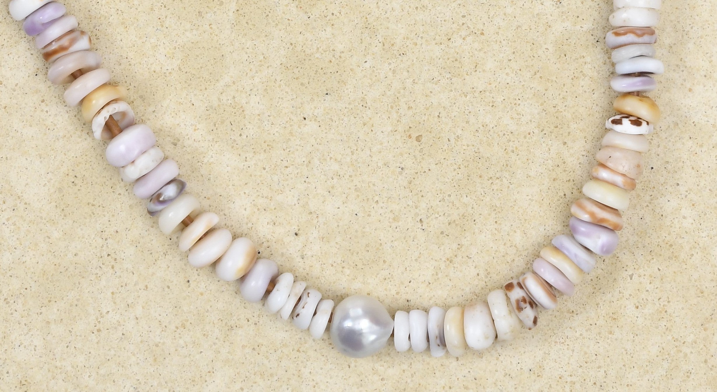 Puka lei with silver Baroque pearl and brown adjustable cord