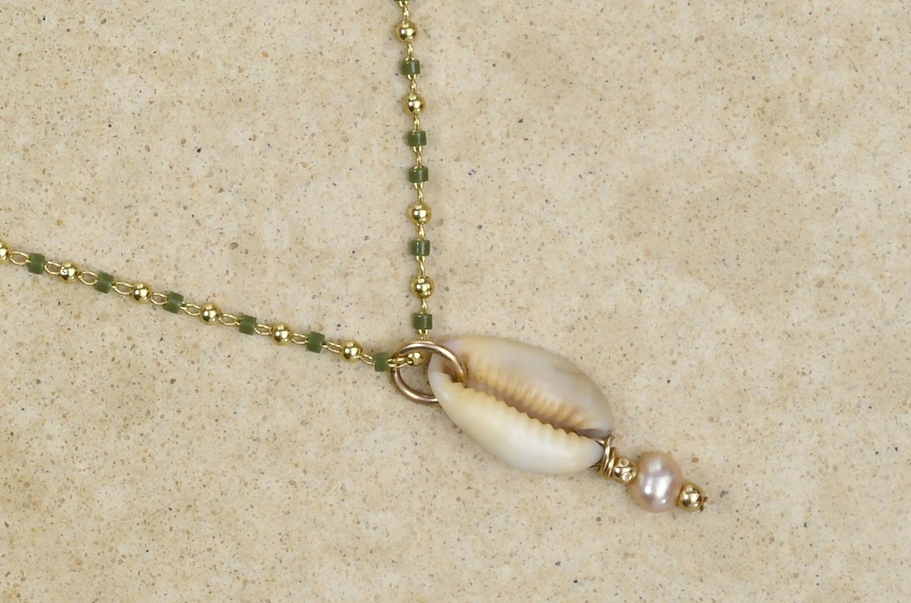 Cowrie lip lei with pearl accent on Delicate Lizard green chain