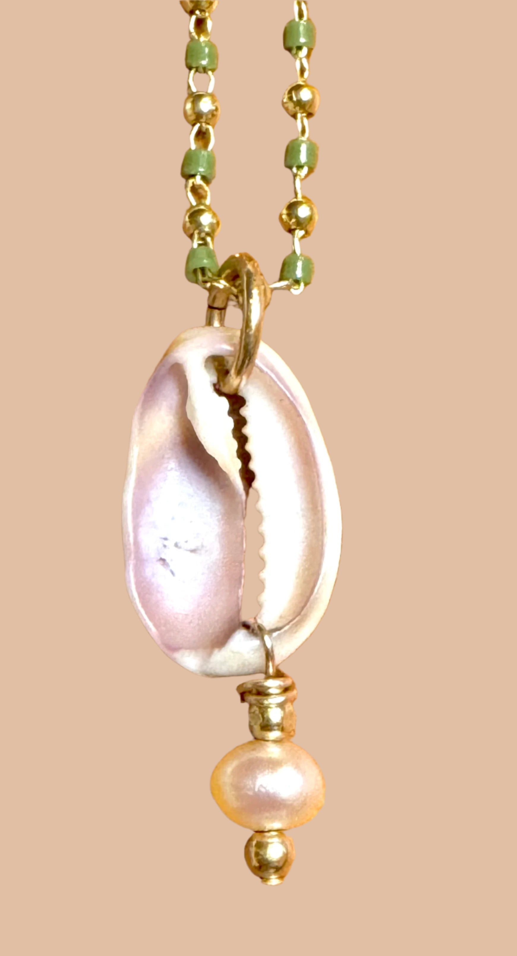 Cowrie lip lei with pearl accent on Delicate Lizard green chain